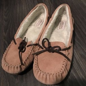 Tan moccasin slippers.